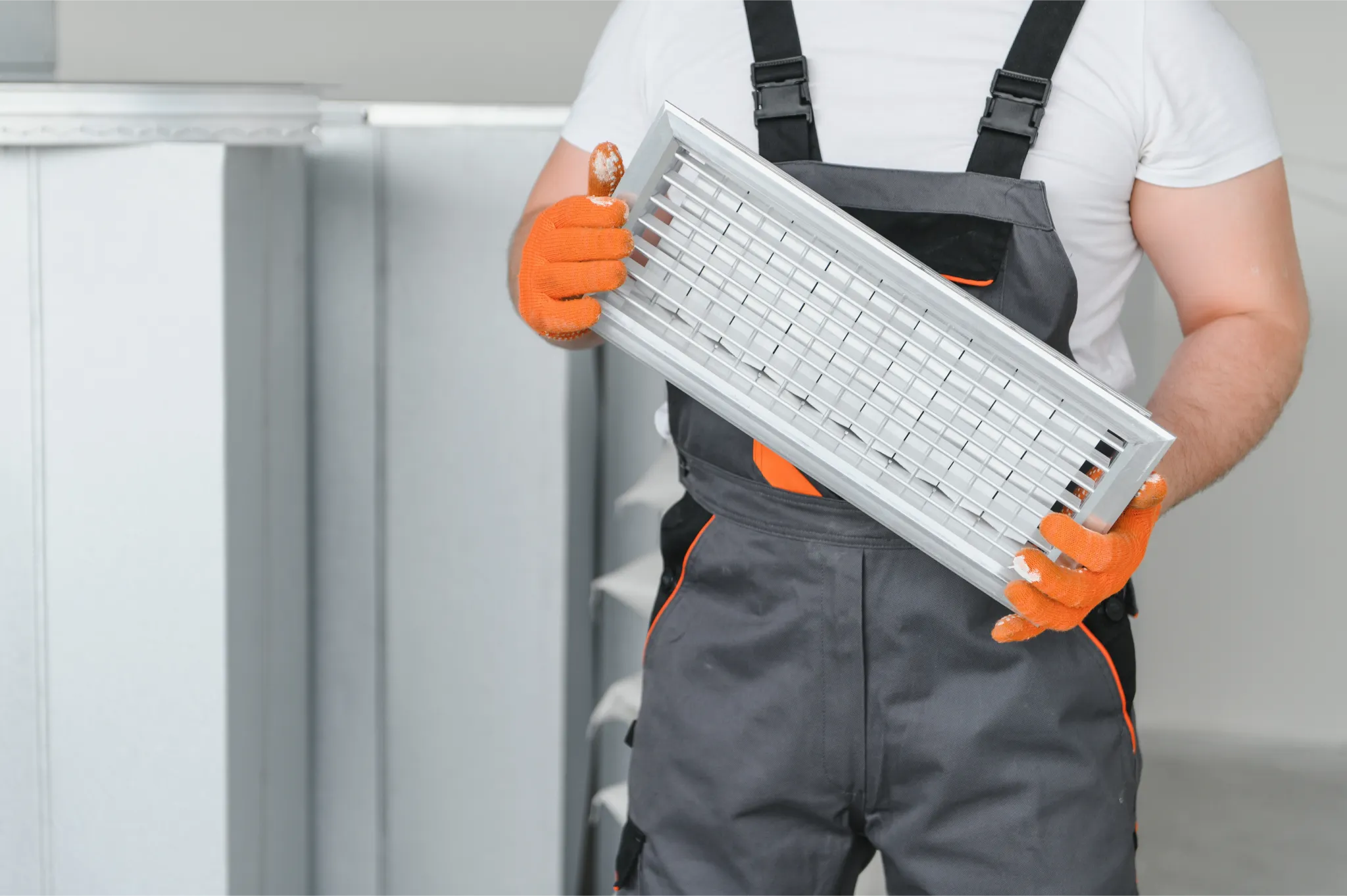 a-male-worker-holds-an-air-filter-for-air-conditio-2025-03-13-16-00-19-utc