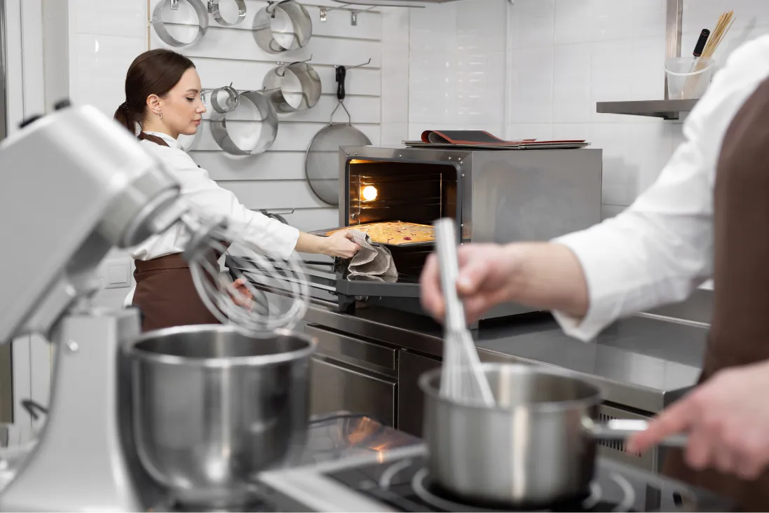 female-pastry-chef-puts-the-sponge-dough-in-the-ov-2025-01-10-20-39-06-utc 1